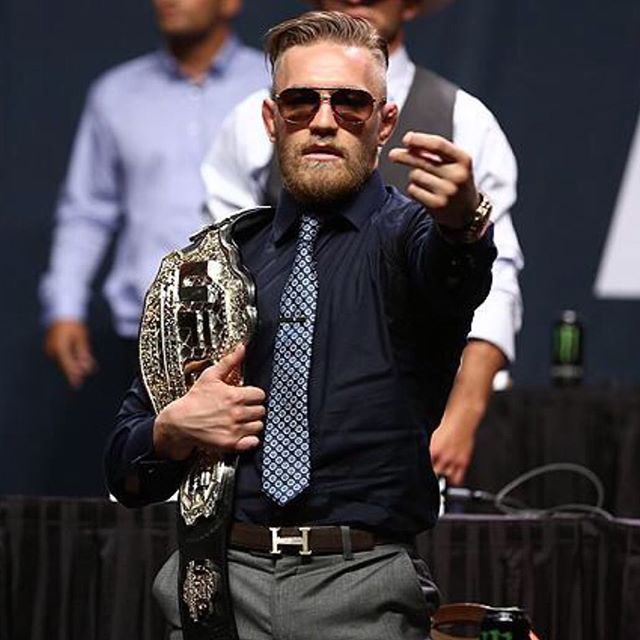 Holding the belt and holding the numbers. Conor McGregor ...